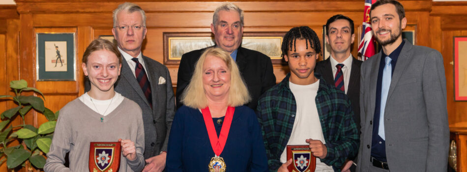 Hannah Sapsford and Zavier Massiah-Edwards stand with their teacher after receiving awards for Academic and Sporting Achievement